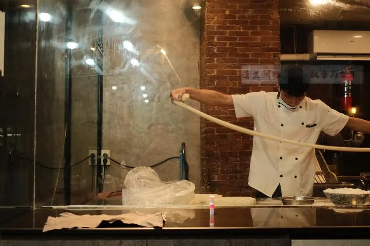 A cook preparing food in an open kitchen