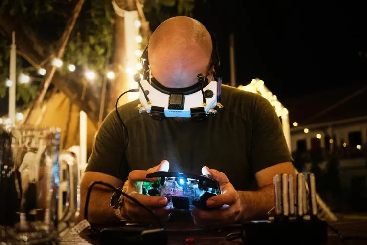 A participant wearing a headlamp concentrating on a hardware device