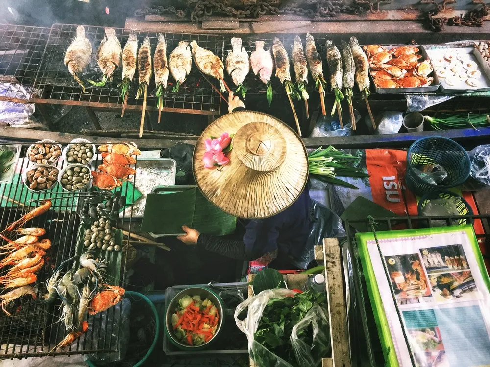 Grilled skewers and Thai street food at a market stall